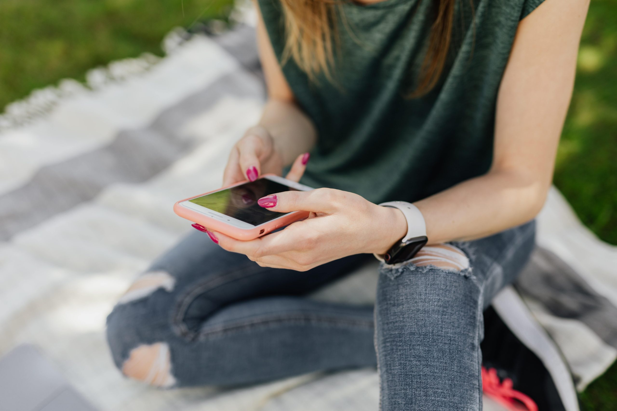 woman direct messaging on her cellphone